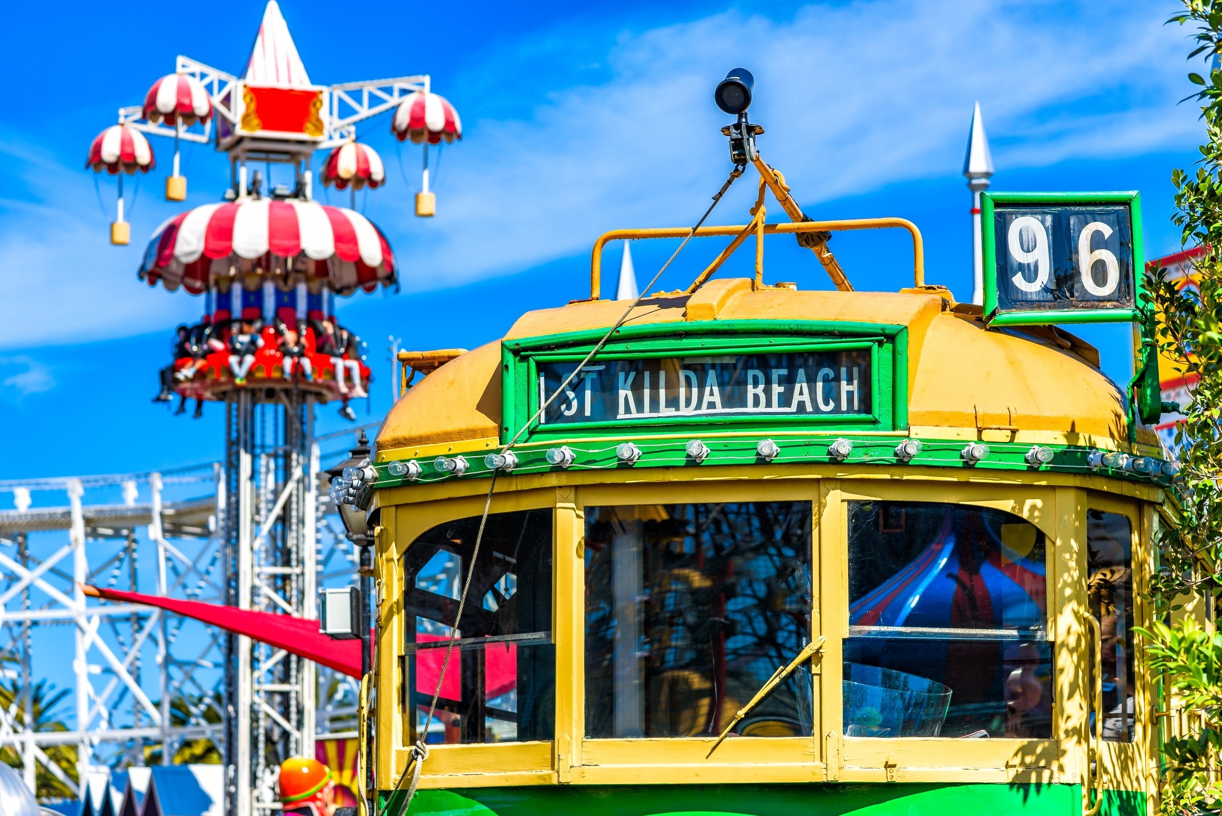 Vintage Melbourne W-Class Tram Images in St Kilda with fun fair rides in the background
