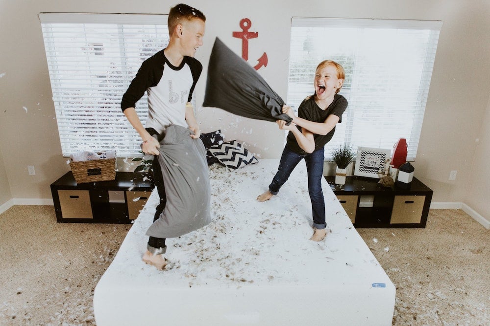Kids having a pillow fight.