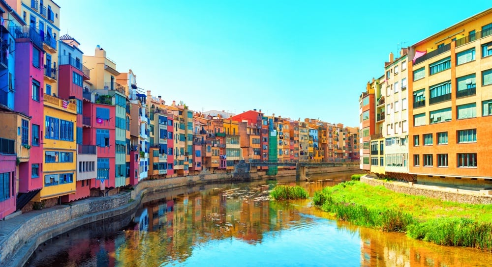 The beautiful, multicolour riverfront tenements of Girona, a sightseeing highlight of a day trip from Barcelona.