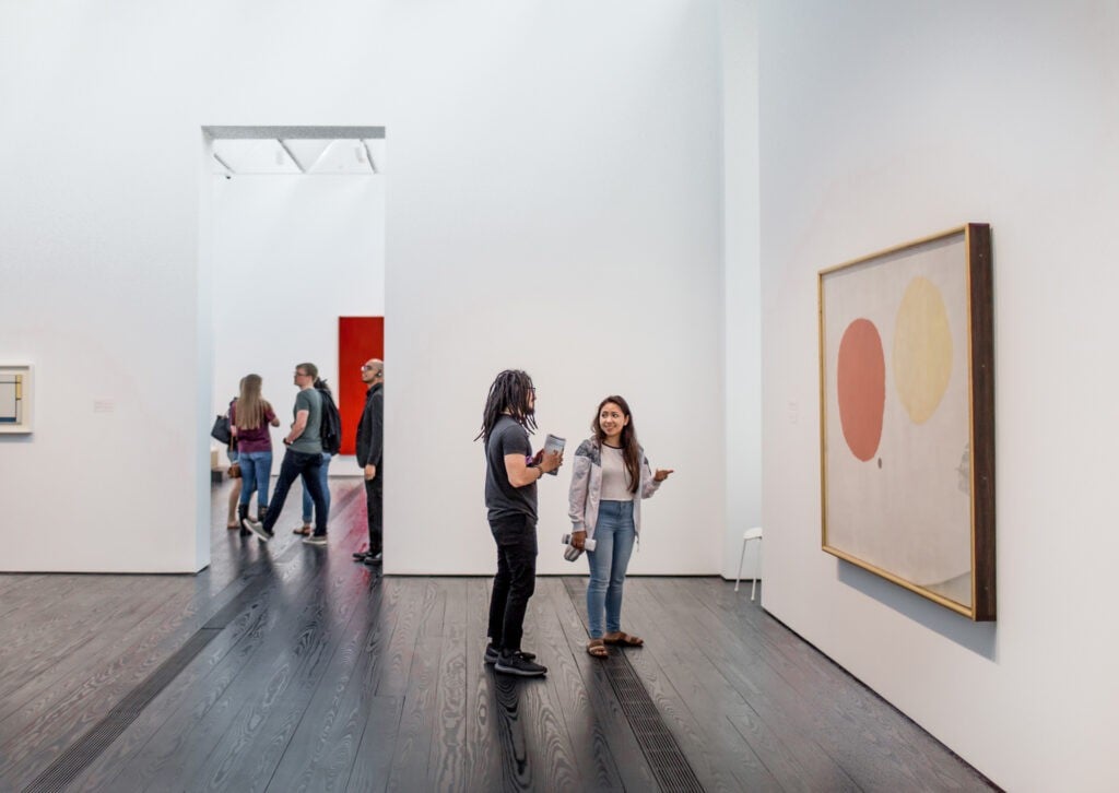 Visitors looking at art inside the Menil Collection, one of the best museums & attractions in the US