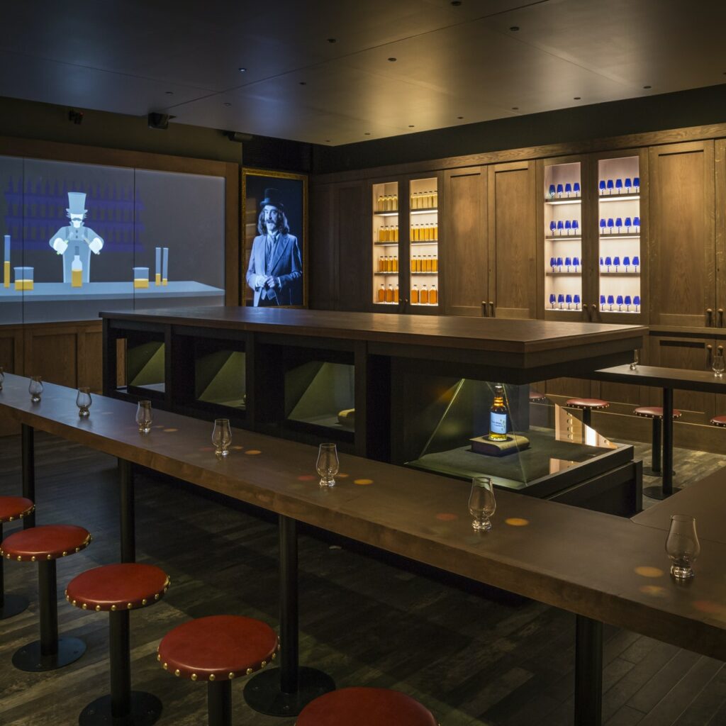 Narrow table around a whiskey centrepiece