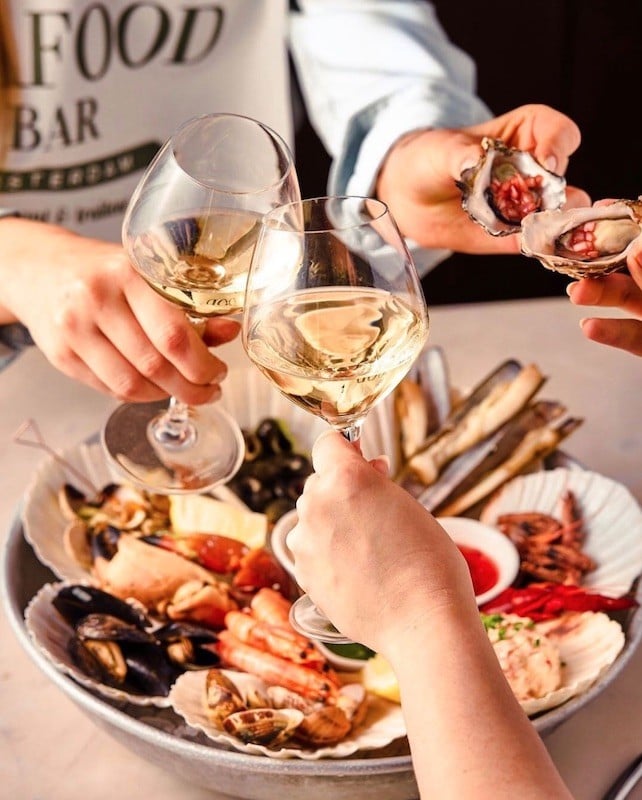 People enjoying food and wine at The Seafood Bar, one of the top seafood restaurants near the van gogh museum