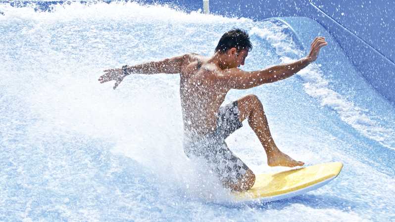 A man catches a wave on a FlowRider board--add this to your list of things to do in Tulum