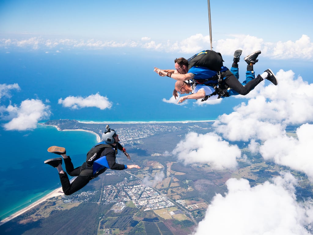 Visitors do skydiving with guidance from a professional on the Gold Coast