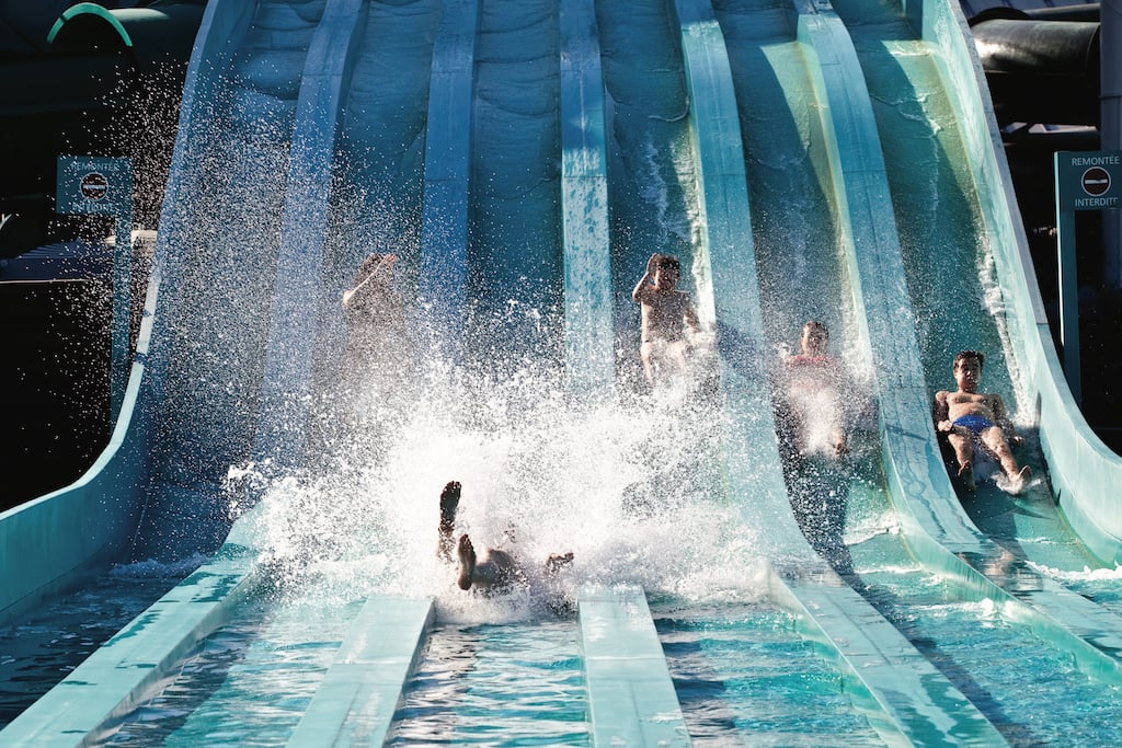 people doing water sliding at the Aquaboulevard