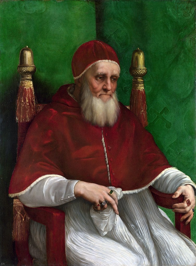 a bearded Pope Julius II is dressed in red garments set against an emerald green backdrop in Raphael's portrait.