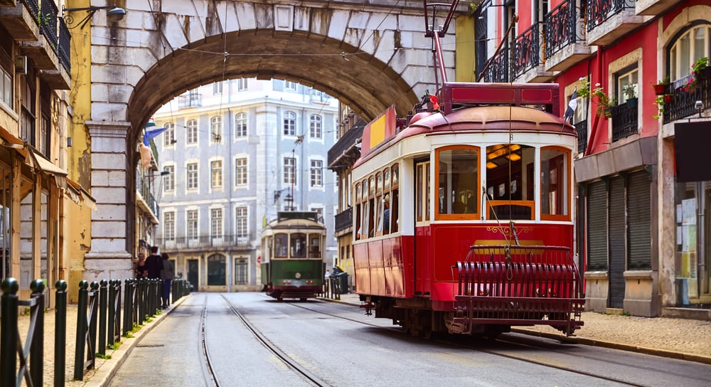 A vintage tram coasts through the historic streets of Lisbon