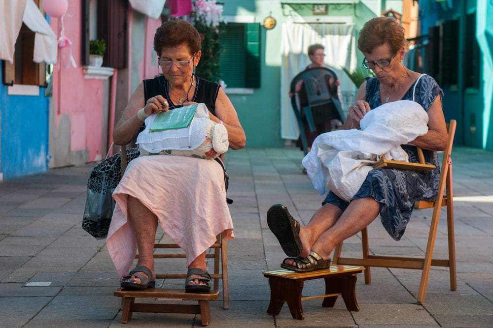 Two Venetian lacemakers hand sew the famous lace "merletto" of Burano