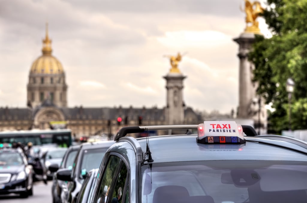 Parisian taxi illuminated sign on the car roof.