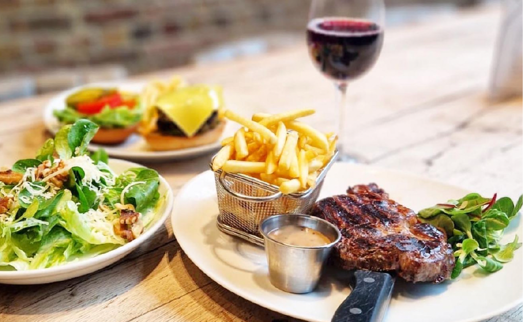 Steak with some fries and fresh salad on the side. 