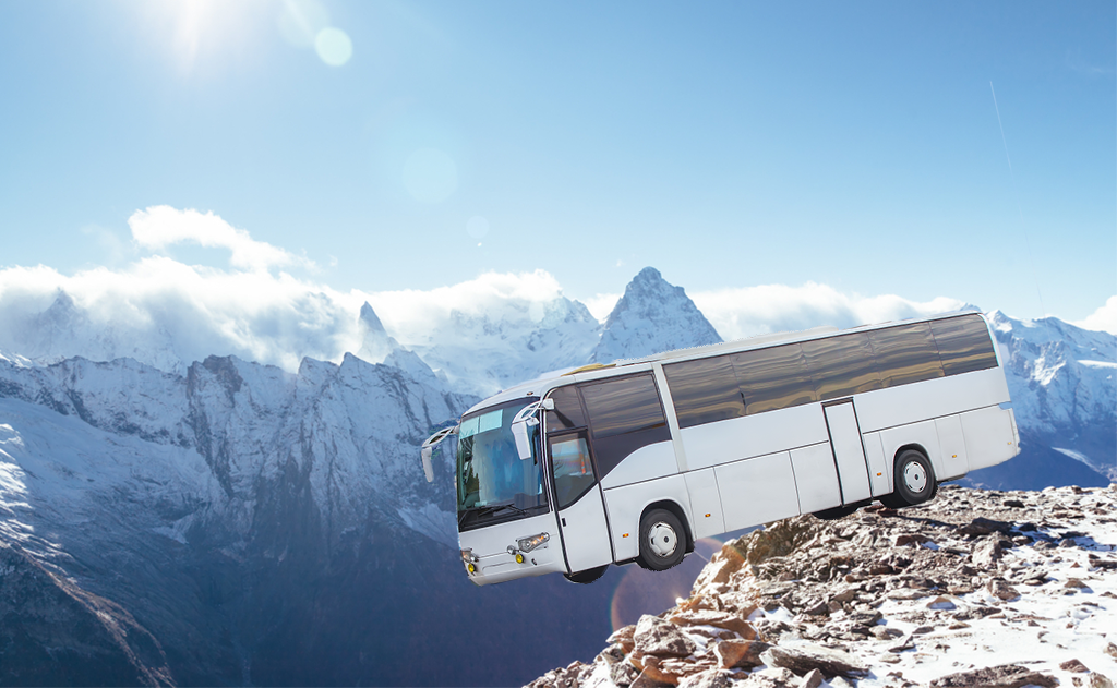 Photoshopped image of the bus hanging on the edge of cliff.