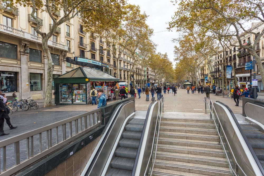 View of the La Rambla, the most popular street in Barcelona. Building facades, entrance to the underpass and metro station.